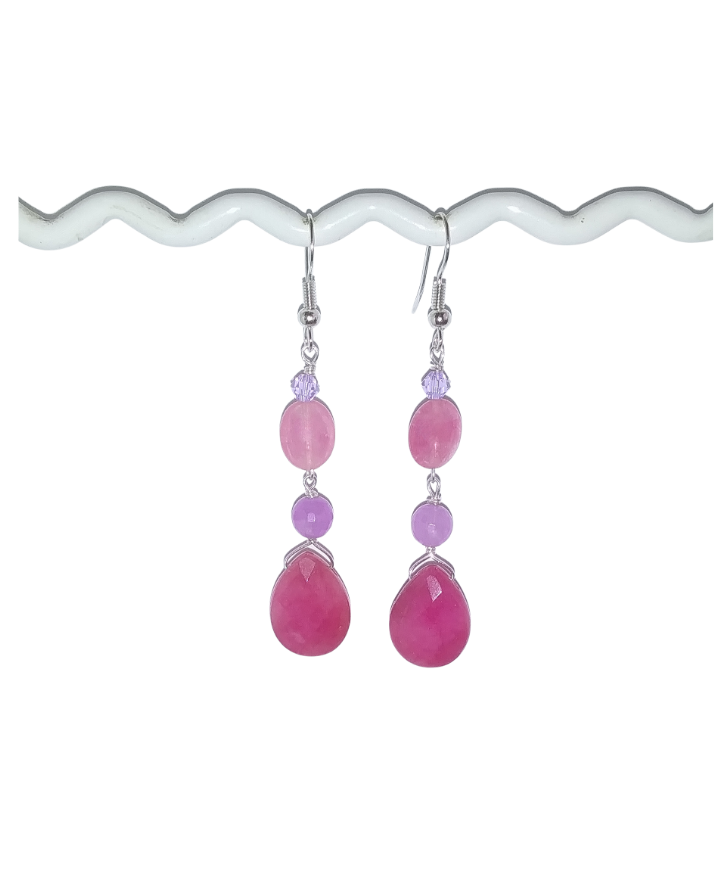 Pink teardrop earrings with purple accents on a white background