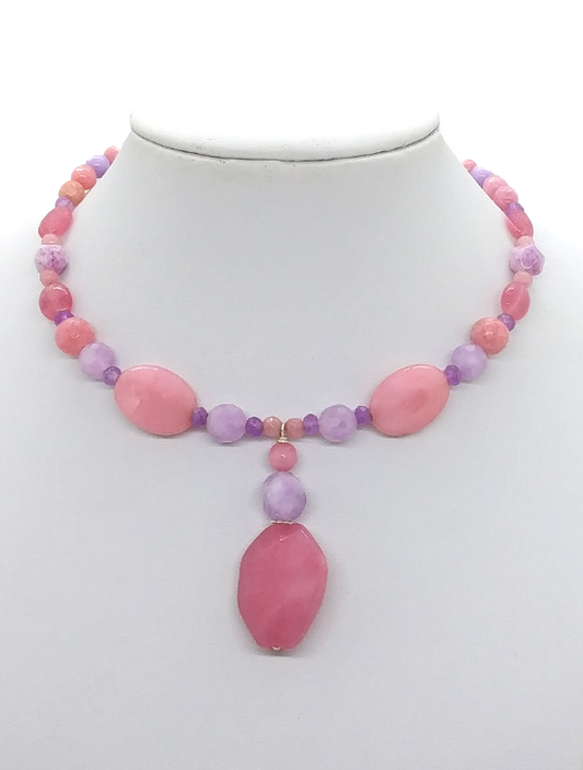 Handmade pink and lilac jade-style gemstone choker necklace on flexible memory wire with a 1 ⅞ inch drop pendant on a white jewelry display.