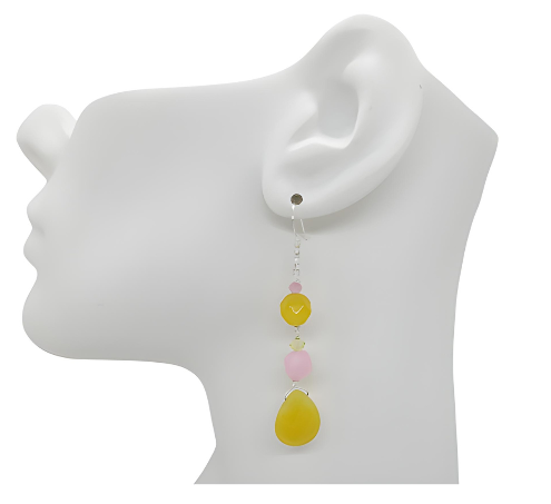 Earring displayed on a mannequin ear with colorful  yellow and pink beads.
