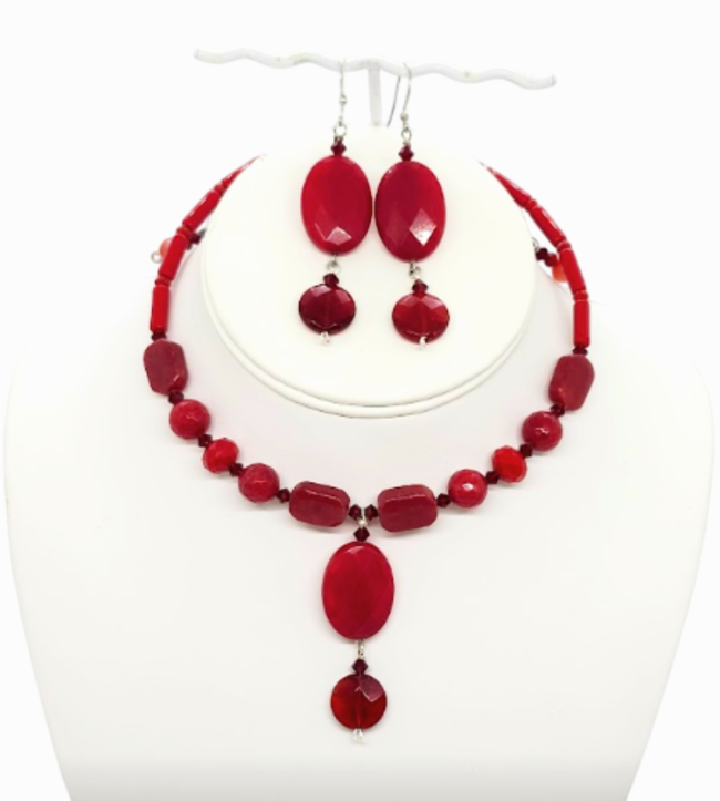 A red beaded jewelry set including a choker-style necklace and matching drop earrings, displayed on a white mannequin bust against a white background.