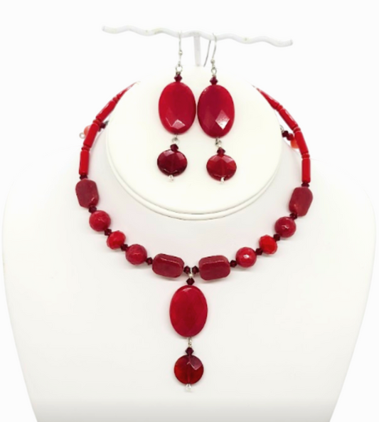 A red beaded jewelry set including a choker-style necklace and matching drop earrings, displayed on a white mannequin bust against a white background.