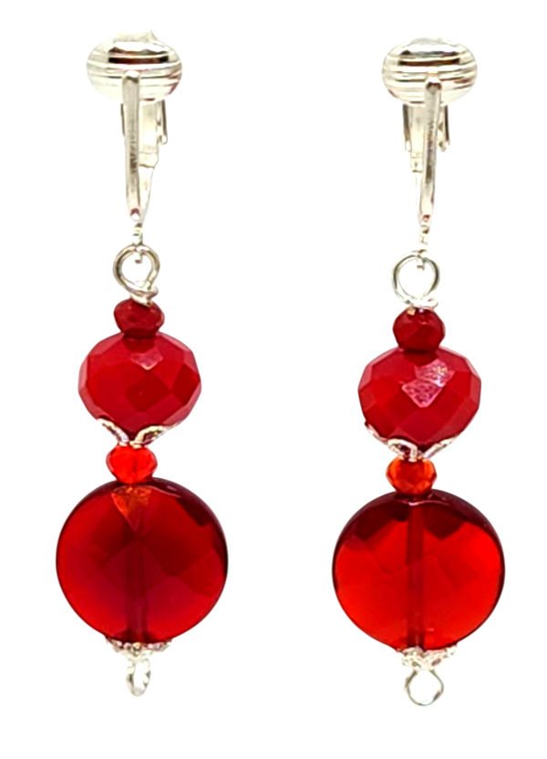 A pair of red beaded dangle clip-on earrings with silver-toned clips, featuring faceted red beads of varying sizes, including the semi-precious stone ruby quartz.