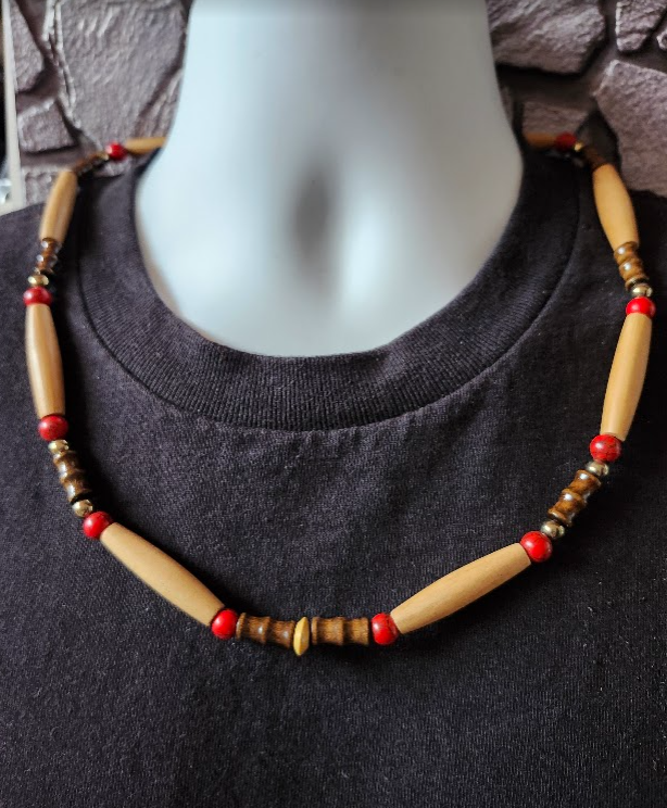 Men's beaded necklace with brown, red and tan beads.  It is composed of natural wood beads, carved bamboo tubes, magnesite stones, and metallic beads.