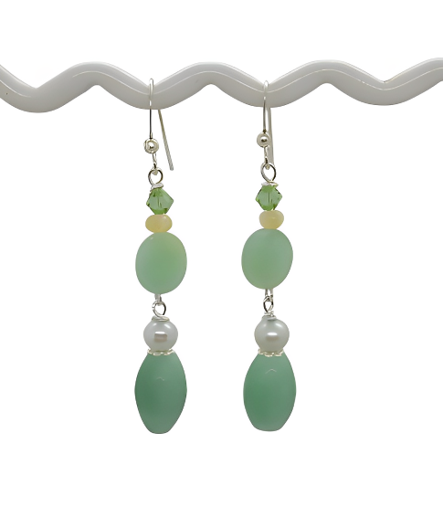 Pair of green beaded earrings on a white background