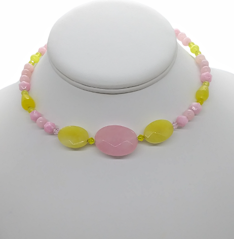 Choker with pink and yellow beads on a mannequin.