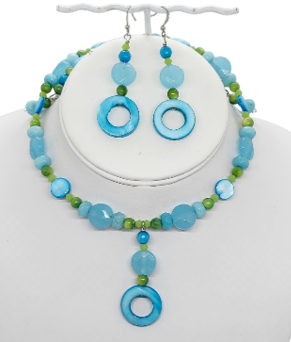 Turquoise, aqua blue and lime green choker style necklace and earrings set composed of semi-precious stones, crystals, and mother-of-pearl shell beads.  The jewelry set  is shown on a white bust display.
