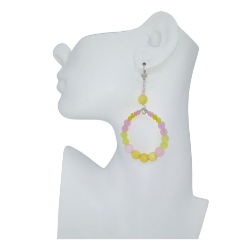 Yellow and Pink beaded earring on a white mannequin bust with a plain white background
